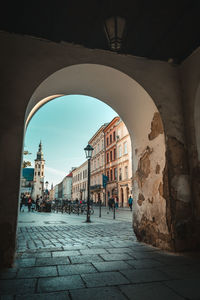 People on street amidst buildings in town