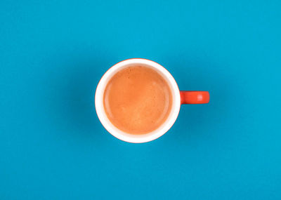 Directly above shot of coffee on table against blue background