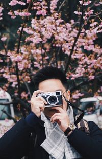 Portrait of woman photographing outdoors