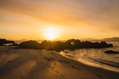 Scenic view of beach against sky during sunset