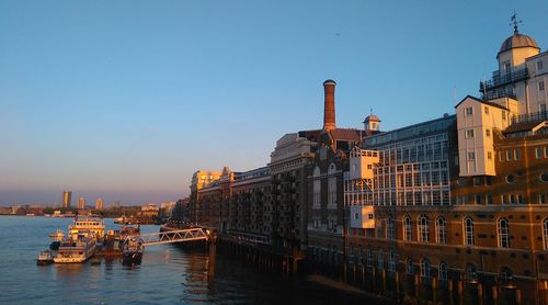 Boats in city against clear sky