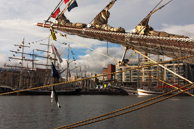 Ship moored at harbor against sky