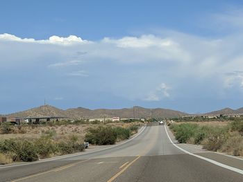 Empty road along countryside landscape