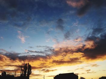 Low angle view of silhouette trees against sky