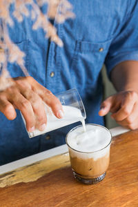 Man holding coffee cup on table