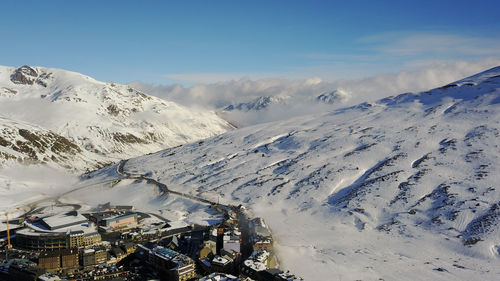 Aerial view of snow covered mountain against sky