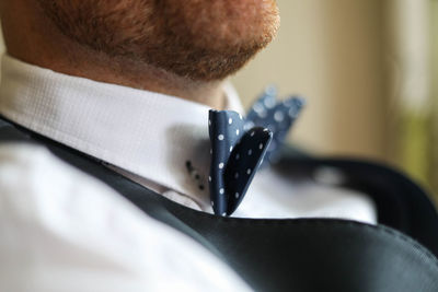Midsection of man wearing bow tie