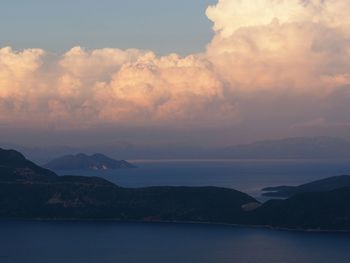 Scenic view of mountains against cloudy sky