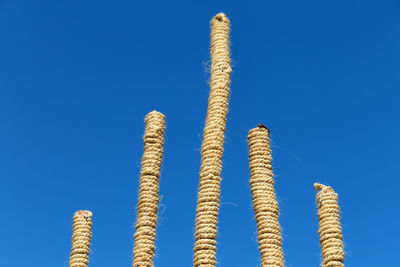 Low angle view of ropes against blue sky