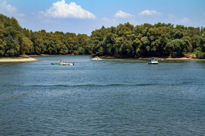 Boats sailing in sea against sky