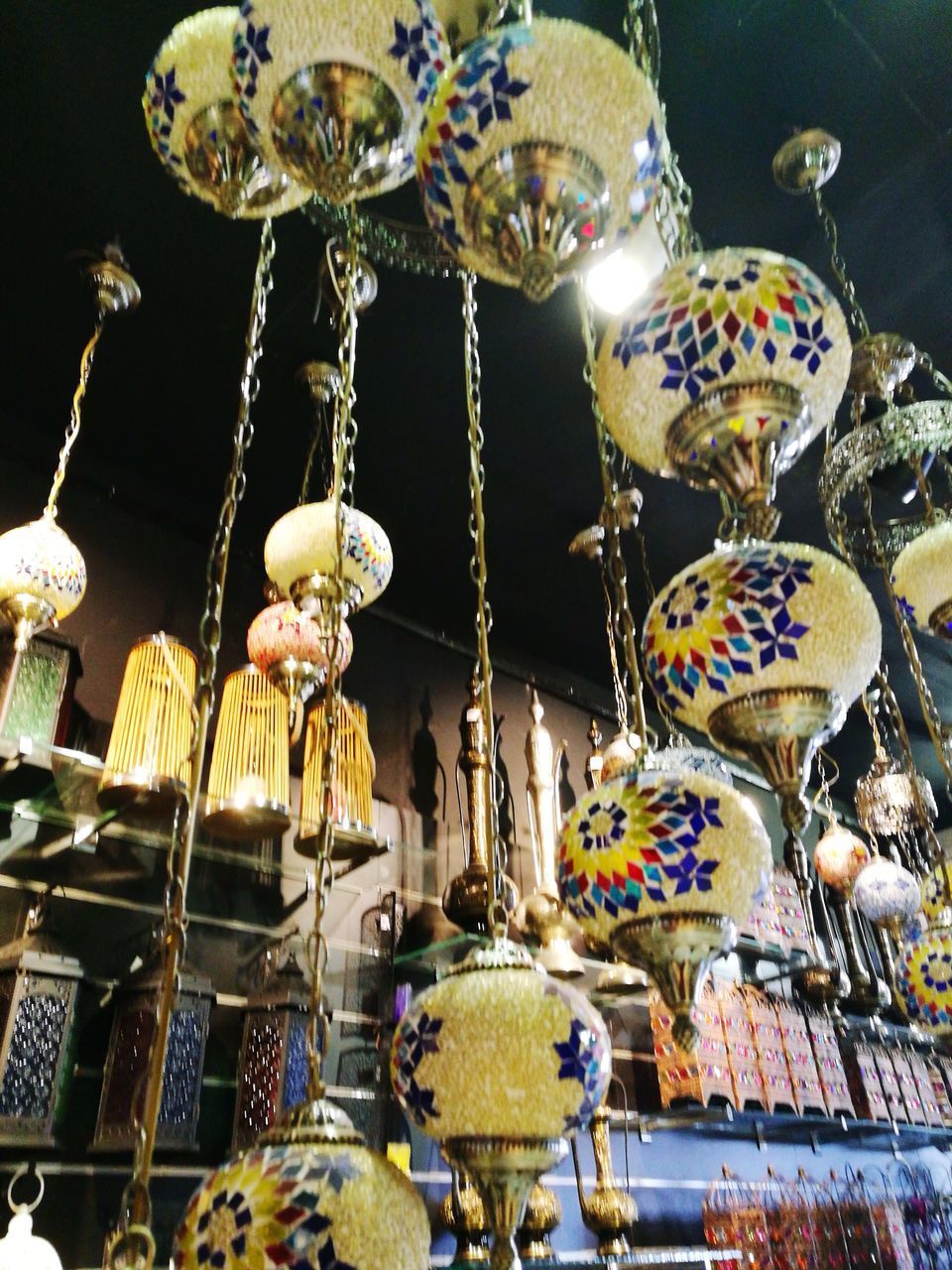 CLOSE-UP OF LANTERNS HANGING ON SHELF