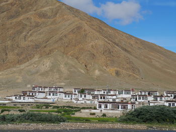 Built structures against mountain and sky