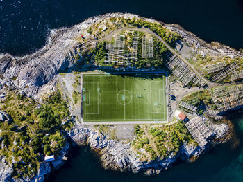 Soccer ground on island by sea at henningsvaer, lofoten, norway