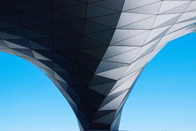 Low angle view of modern building against blue sky