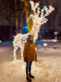 Full length of woman standing in snow