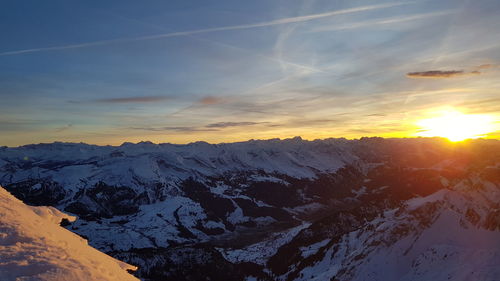 Scenic view of snowcapped mountains against sky during sunset