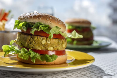 Homemade healthy vegan green lentil burger with tomato, lettuce and french fries