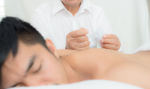 Midsection of couple holding hands