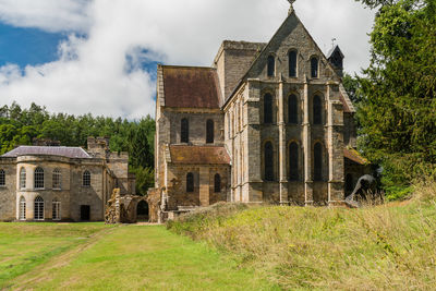 Historic building on field against sky