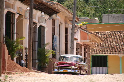 Vintage car on street by residential building