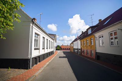 Street amidst buildings against sky