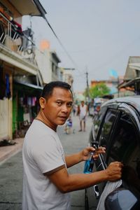 Man standing on street in city