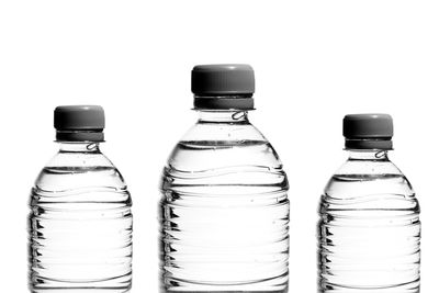 Close-up of water bottles against white background