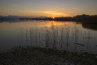 Scenic view of lake against sky during sunset