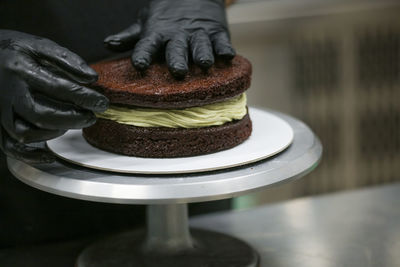 Midsection of man holding cake