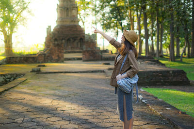 Woman standing by tree in park