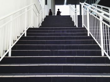 Low angle view of people walking on stairs