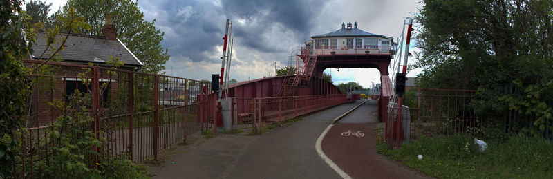 Panoramic view of road amidst buildings against sky