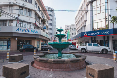 Cars on street against buildings in city