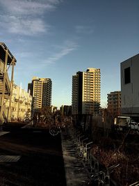 Street amidst buildings against sky in city