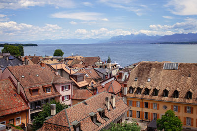 High angle view of townscape by sea against sky