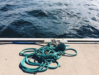 High angle view of rope tied to boat moored at harbor