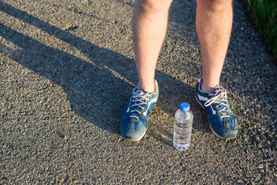 Low section of person standing on road