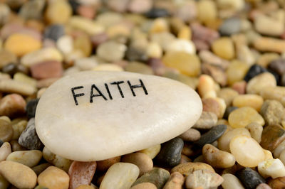 Close-up of text on pebbles