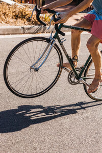 Low section of man riding bicycle on street