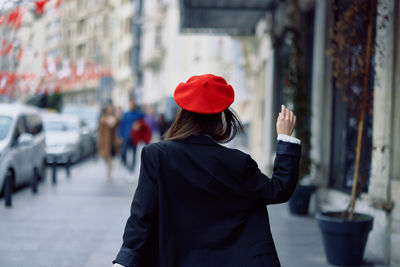 Side view of woman standing in city