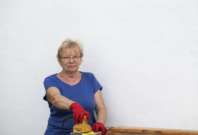 Full length of woman on table against wall