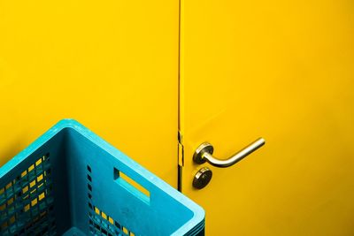 Close-up of yellow metal door of building