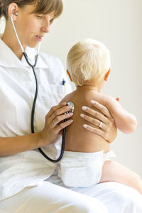 Doctor examining baby at clinic