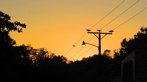 Low angle view of silhouette trees against sky during sunset