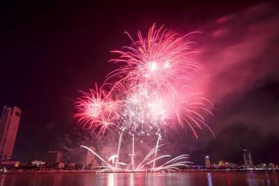 Low angle view of firework display at night