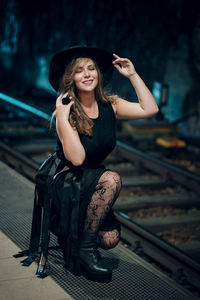 Portrait of woman sitting in hat