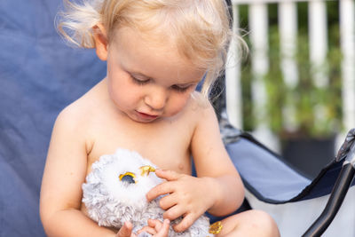 Portrait of cute girl playing with toy