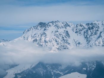 Scenic view of snow covered mountains against sky