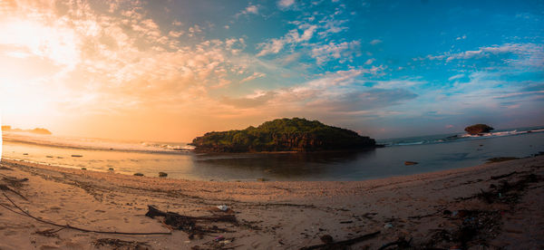 Scenic view of beach against sky during sunset