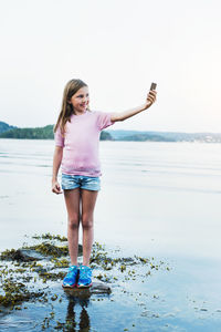 Girl taking selfie with cell phone